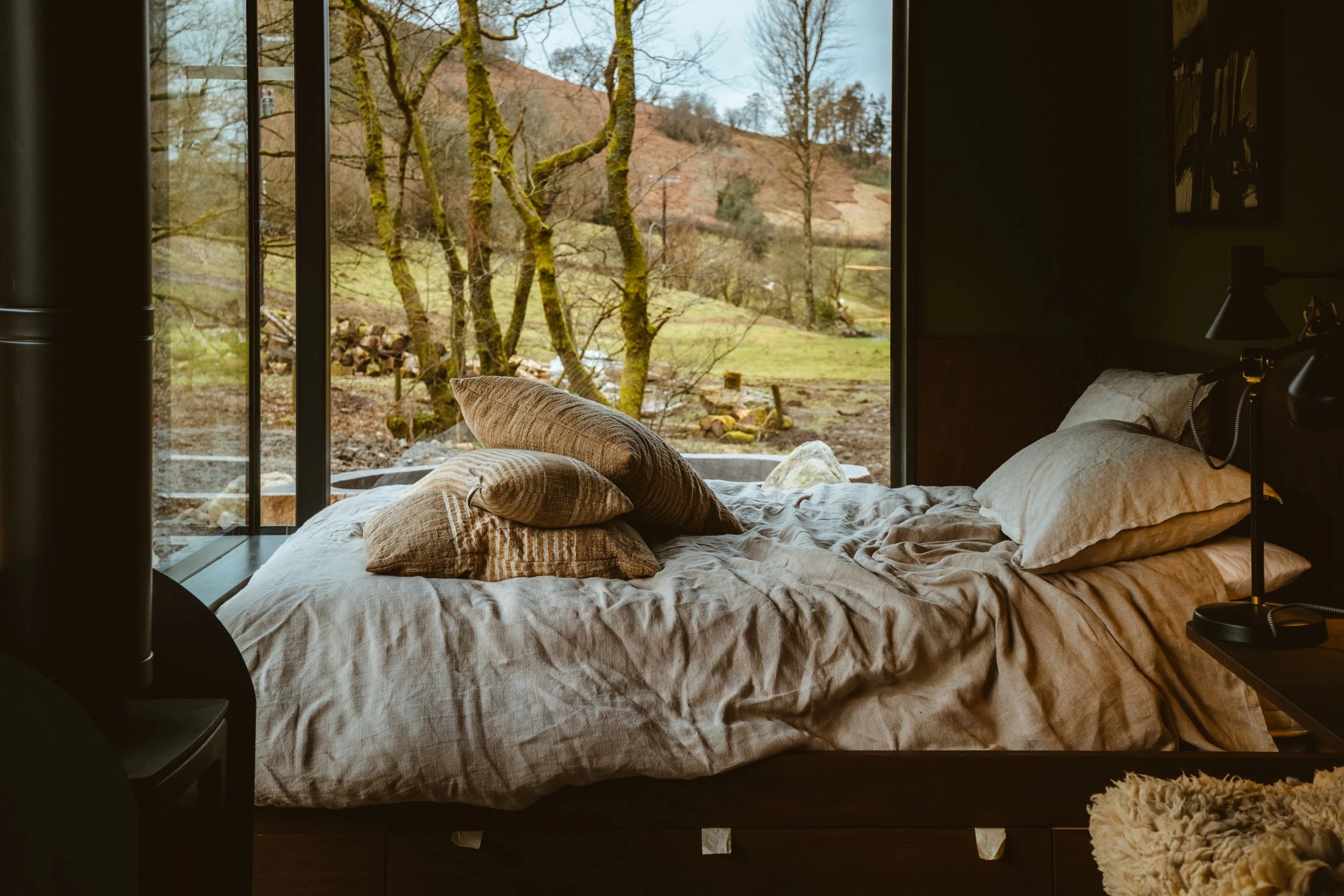Warm bedroom interior overlooking the woodland